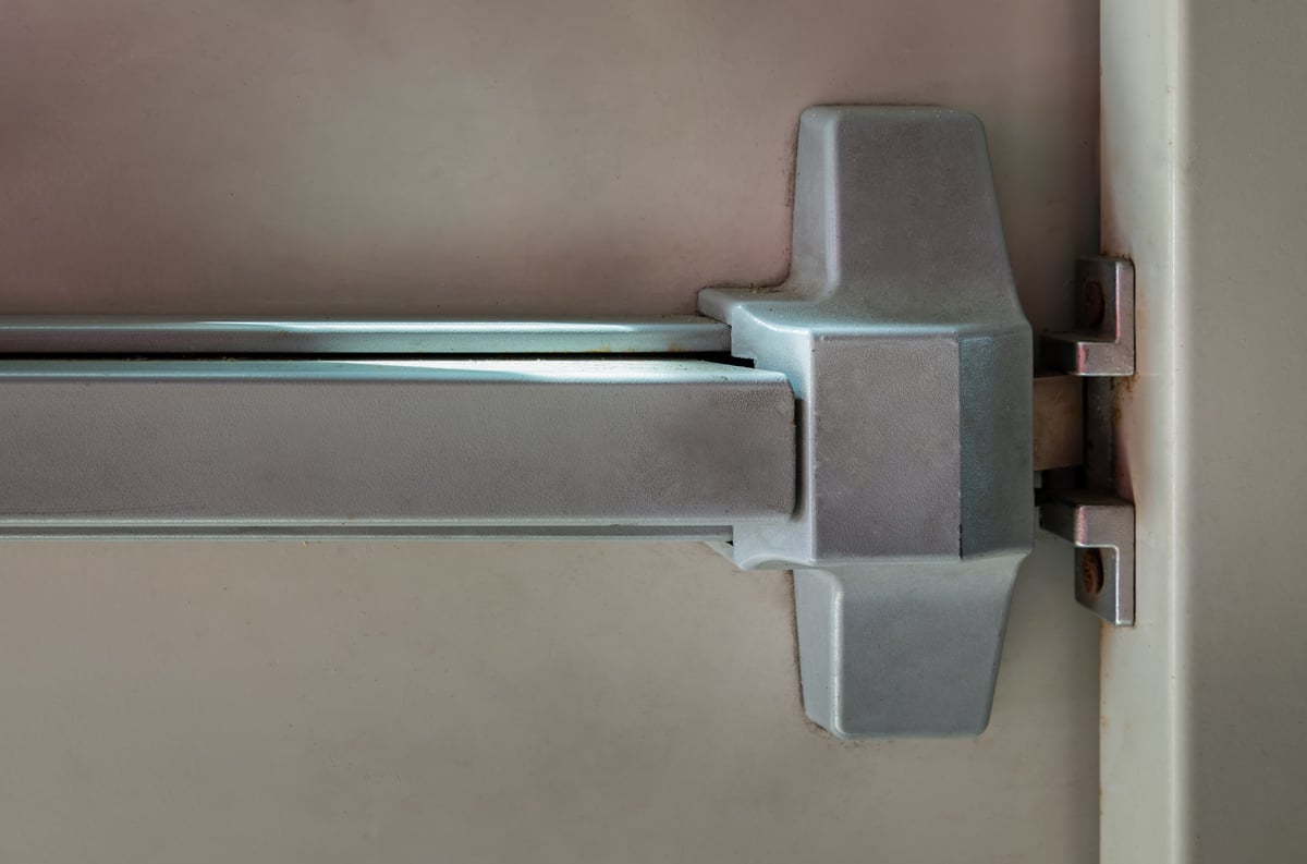 Close-up of latch and door handle of emergency exit with push bar