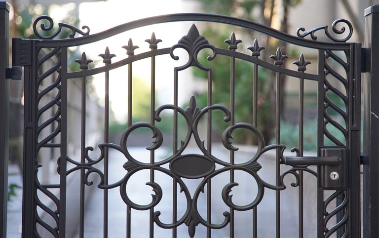 Ornate wrought iron swinging gate