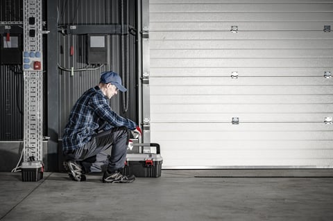 Professional garage door technician servicing a residential garage door in Coquitlam BC