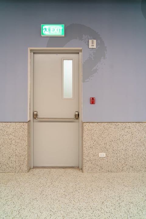 Emergency exit door with push bar in underground parking lot for fire safety in Coquitlam BC