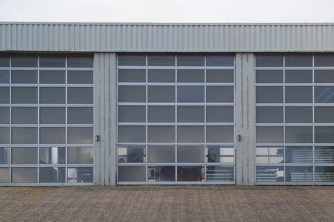 Sectional overhead glass garage doors allowing natural light