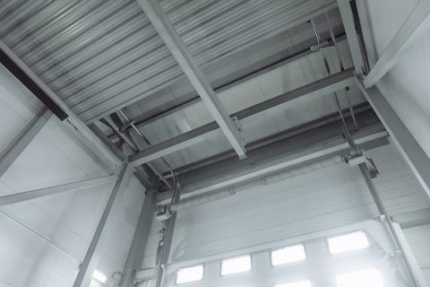 Mechanism of sectional overhead gate inside a cargo garage
