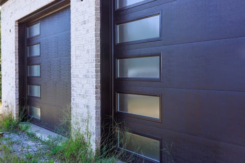 Modern black garage door with glass panels