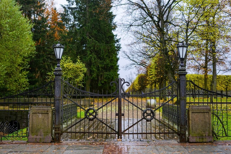 Elegant wrought iron swinging gate with lanterns