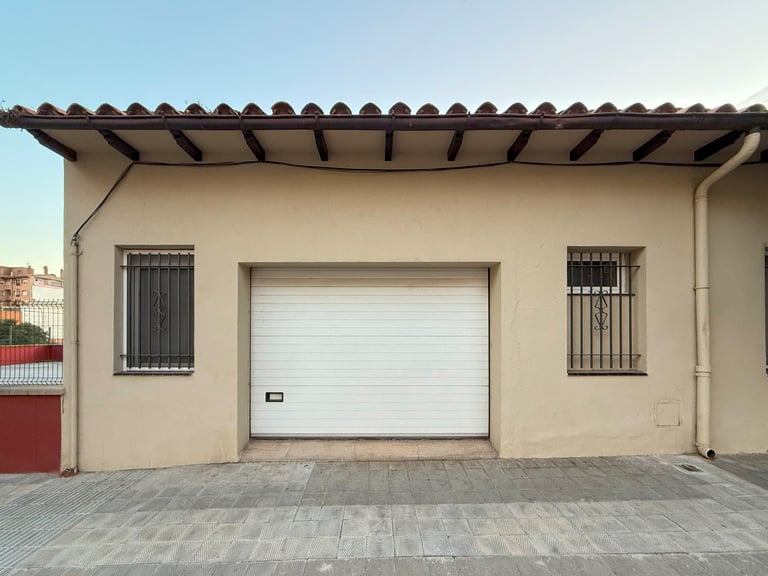 Beige stucco house with new white garage door
