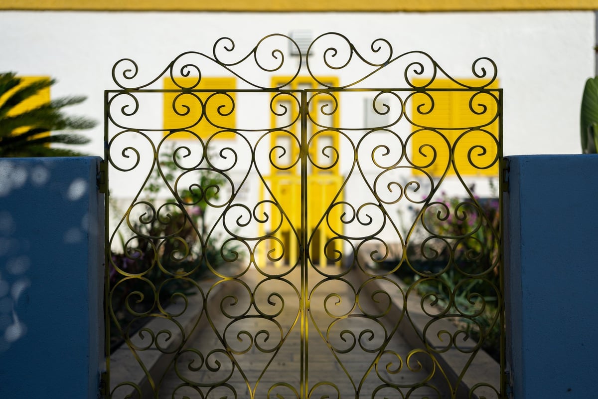Decorative gate framing a building view with elegant design