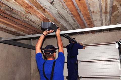 Professional technician installing a modern garage door opener in a Coquitlam home