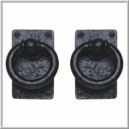 Pair of black antique metal ring pull handles with weathered rectangular mounting plates