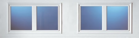 Two white window frames side by side, each containing two panes with blue gradient glass