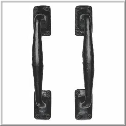 Two black weathered door handles with curved grips mounted on rectangular backplates