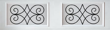 Two decorative scrollwork panels with black ornamental swirls and geometric patterns on white backgrounds