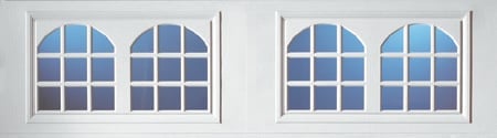 Two pairs of arched double-pane windows with white frames and grid divisions
