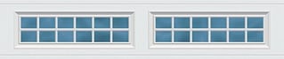Two white garage doors with blue rectangular panel windows arranged in a grid pattern