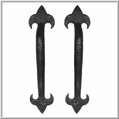 Pair of black ornate wrought iron door handles with curved ends and decorative floral-style ends