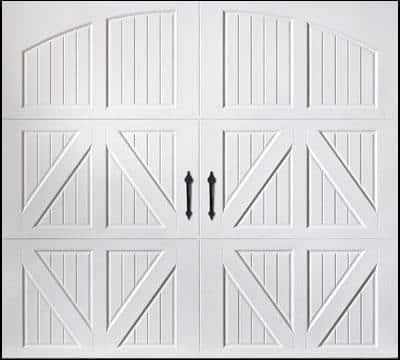 White double garage door with decorative arched panels, vertical lines, and X-pattern design in lower sections