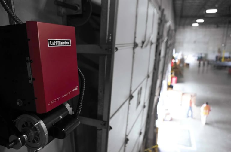 LiftMaster commercial opener mounted on wall with industrial warehouse
