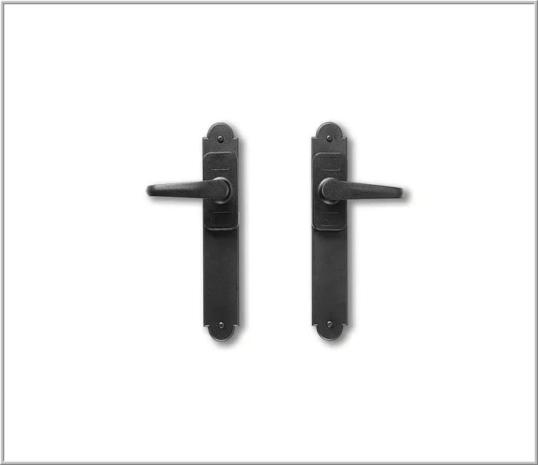 Pair of black ornate door handles with lever-style handles and decorative backplates on white background