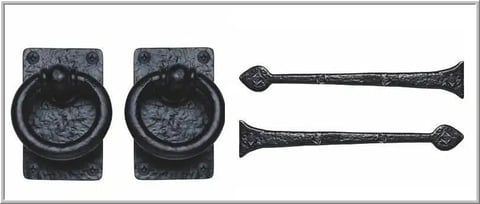 Black iron door hardware set with two ring knockers and two handles against white background