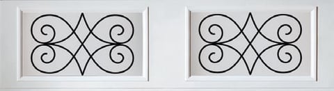 Two wrought iron decorative panels with symmetrical scrollwork and diamond geometric patterns